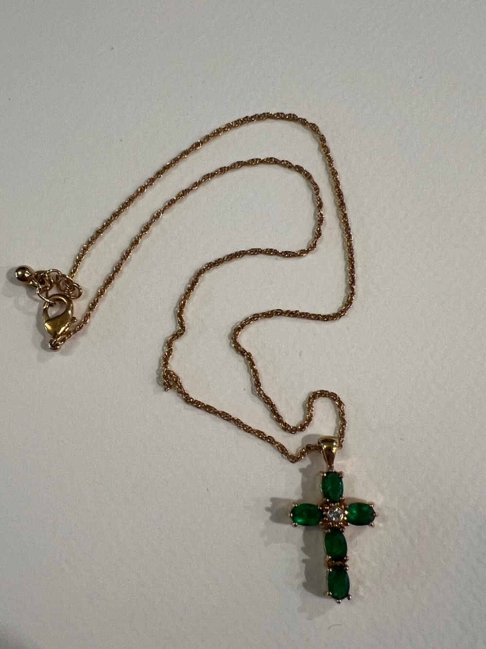 Avon ‘NR’ Gold-tone Cross Necklace with Green Gemstones